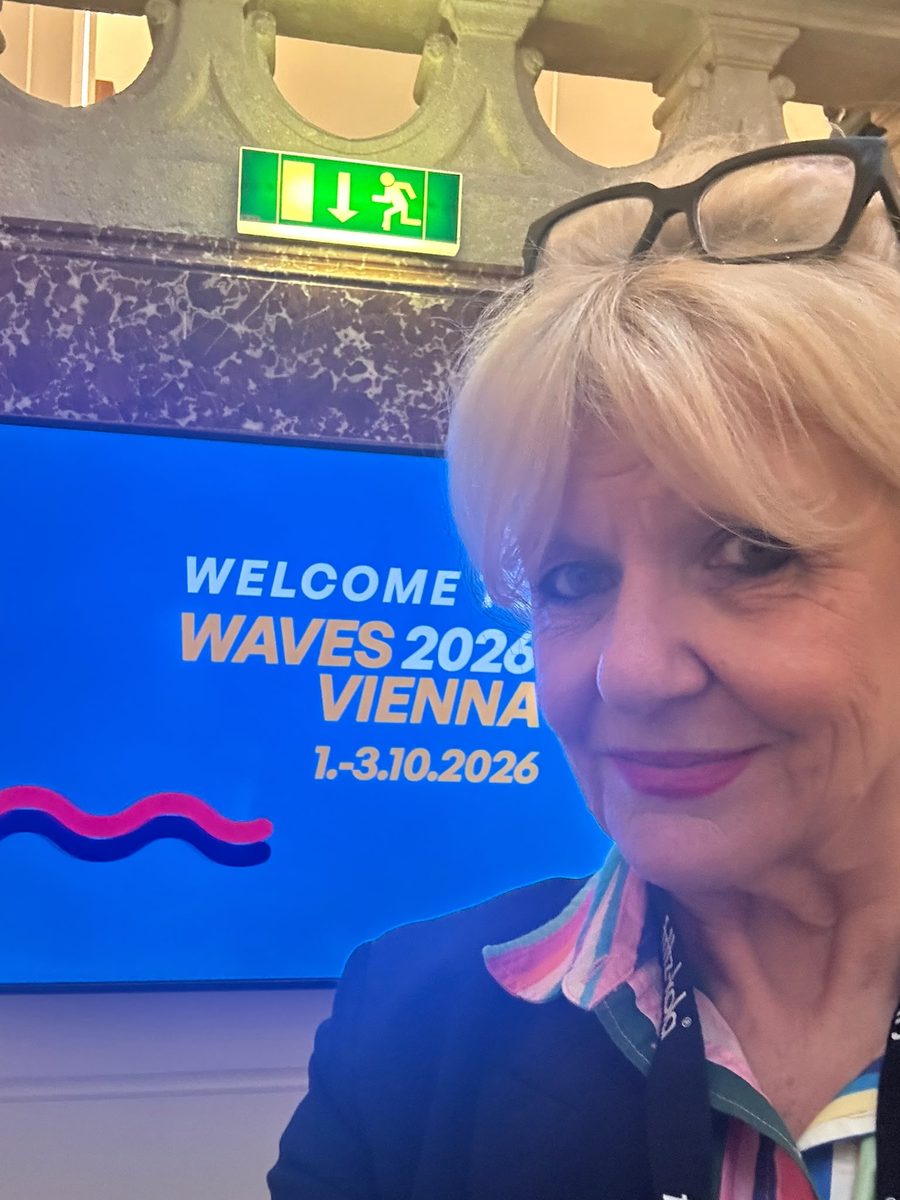 Gill Morris in front of the Welcome to Waves 2026 Vienna screen