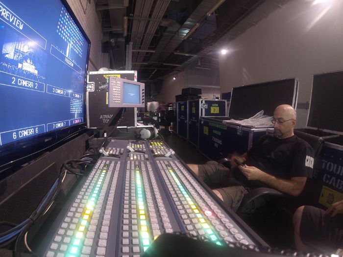 Tim Brennan sitting in front of a Sony MVS 6000 vision mixing desk on Rihanna's Diamonds tour